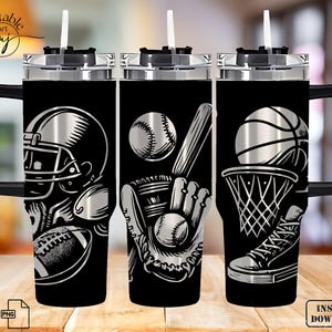 May include: Black tumbler with a silver sports theme. Designs include a football helmet and ball, baseball with bat and glove, and a basketball with a hoop and sneaker. The tumbler has a black handle and a straw.