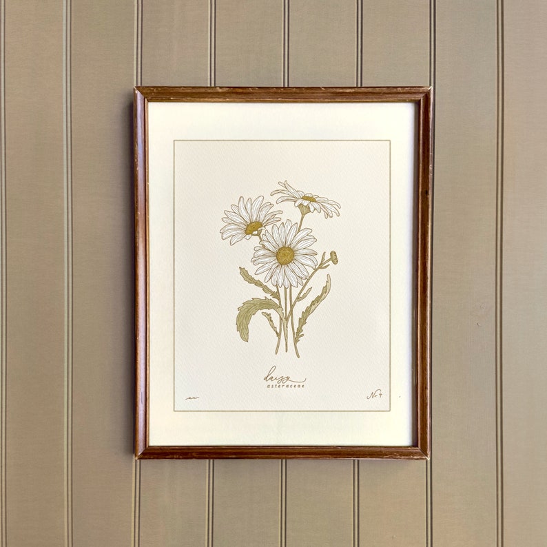 Three white daisy flowers art print.  Wooden frame on bead board.