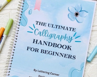 May include: A blue and white spiral bound notebook with the title "The Ultimate Calligraphy Handbook for Beginners" and the text "By Lettering Corner" and "Reach us at: FACEBOOK: Lettering Corner INSTAGRAM: Lettering corner".