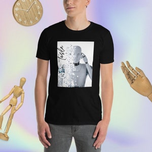 May include: A black t-shirt with a graphic of a robot's head with the word "Tesla" written diagonally across the image.