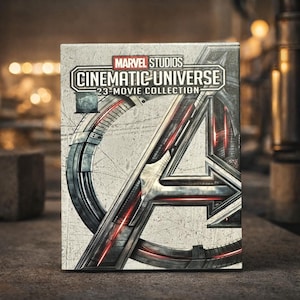 May include: A Marvel Studios Cinematic Universe 23-Movie Collection box set. The box features the Avengers "A" logo in silver and red, with the title text in a silver, industrial style font. The background is a textured, light gray.