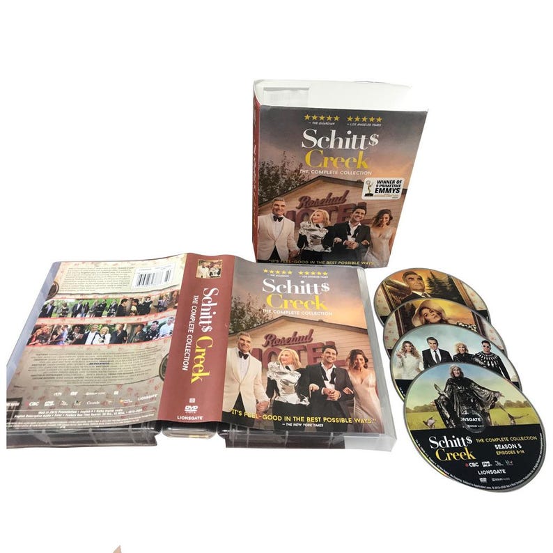 May include: The complete collection of Schitt's Creek on DVD. The box set includes a cardboard box, a DVD case, a DVD case insert, and several DVDs. The box set features the show's title and cast.