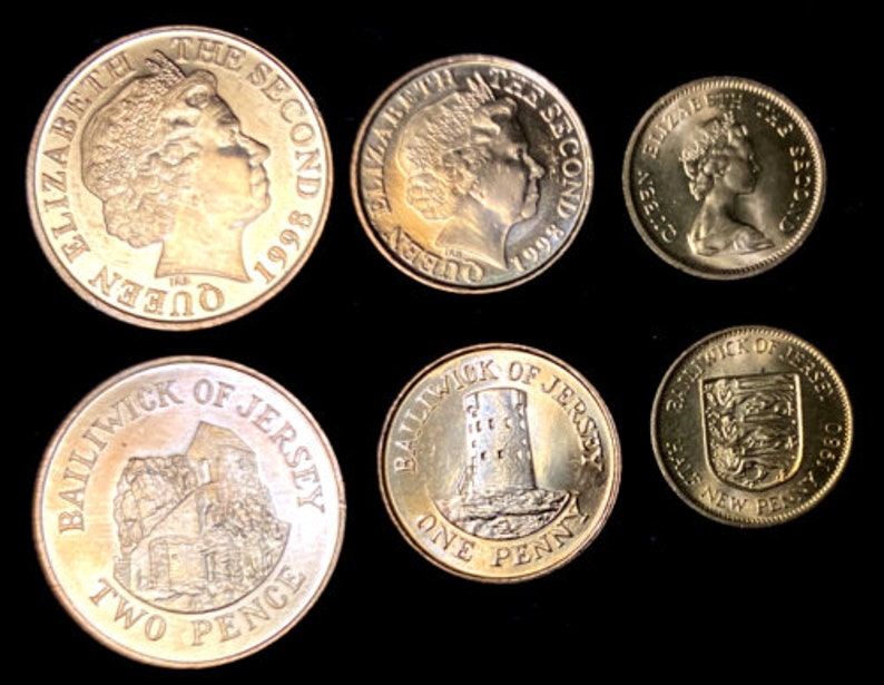 May include: A collection of six gold-colored coins featuring the profile of Queen Elizabeth II and the text "Queen Elizabeth II The Second 1998" on one side and the text "Bailiwick of Jersey" and the denomination on the other side.