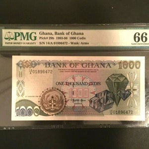 May include: A 1000 Cedi banknote from Ghana, issued in 1993-96, graded 66 Gem Uncirculated by PMG. The note features a green and red design with a diamond motif and the text "BANK OF GHANA" and "ONE THOUSAND CEDIS".