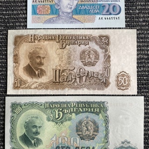 May include: Three Bulgarian banknotes, one 20 leva, one 50 leva, and one 100 leva. The 20 leva banknote features a portrait of Tsaritsa Maria, the 50 leva banknote features a portrait of a man, and the 100 leva banknote features a portrait of a man. All three banknotes feature the Bulgarian coat of arms.