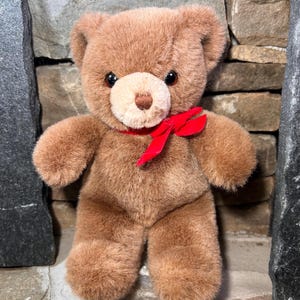 GUND 1989 Brown Teddy Bear Vintage soft with red ribbon bow. He has a hard eyes and a sewn nose.
