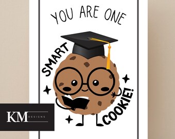 May include: A greeting card with a cartoon cookie character wearing a graduation cap and glasses. The card has the text "YOU ARE ONE SMART COOKIE!" in black, with a white border and a logo in the bottom left corner.
