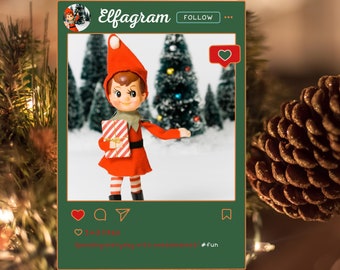 Puede incluir: Una muñeca elfo navideña vintage con un atuendo rojo, sosteniendo un regalo envuelto. La muñeca posa en un marco de redes sociales con el texto "Elfagram" y "Follow". El fondo presenta árboles nevados. La publicación incluye un icono de corazón y el texto "Spending everyday with sweetness! #fun".