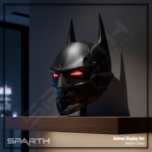 Könnte beinhalten: Ein schwarzer Batman-Helm mit leuchtend roten Augen, ausgestellt auf einem Holzregal. Der Helm hat spitze Ohren und ein detailliertes, eckiges Design. Der Text "Helmet Display Set" ist sichtbar.