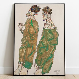 May include: A framed print of an abstract artwork featuring two figures in long, draped garments. The figures are rendered in a palette of earthy browns, greens, and touches of red and blue. The artwork has a raw, expressive style, with visible brushstrokes.
