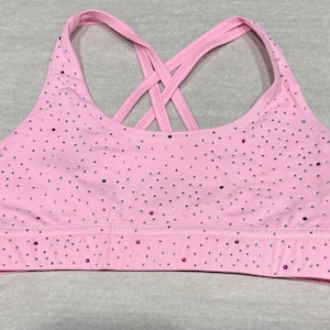 May include: A white ceramic mug with a black handle and the text "But First, Coffee" in a bold, black font. The mug is set against a neutral background, highlighting its simple design.