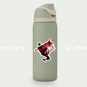 May include: A green reusable water bottle with a white lid and a sticker of a cartoon superhero in a red and black suit. The sticker says "Hello There" in red letters.