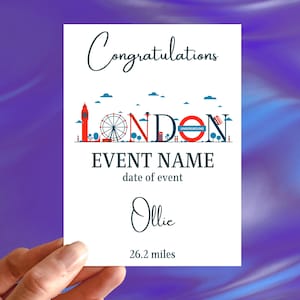 May include: A white card with the word "Congratulations" in cursive script. Below, a London skyline design in red, blue, and white. The card includes the text "EVENT NAME", "date of event", the name "Ollie", and "26.2 miles".