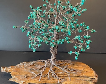 Wire tree with green beads attached to a piece of driftwood from Vancouver Island, Canada