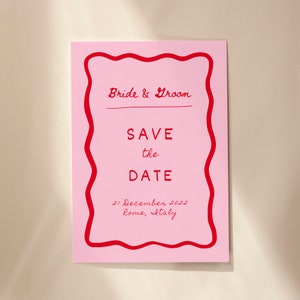May include: Pink save the date card with a red wavy border. The text reads "Bride & Groom" and "Save the Date" with the date "21 December 2022" and location "Rome, Italy" in red.