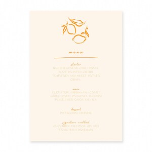 May include: A cream-colored menu card with an orange illustration of lemons and leaves at the top. The menu lists starters, main courses, dessert, and a signature cocktail. The text is in a simple, elegant font.