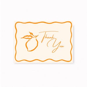 May include: A cream-colored card with an orange border and a stylized orange lemon illustration. The words "Thank You" are written in elegant script, making it suitable for expressing gratitude.