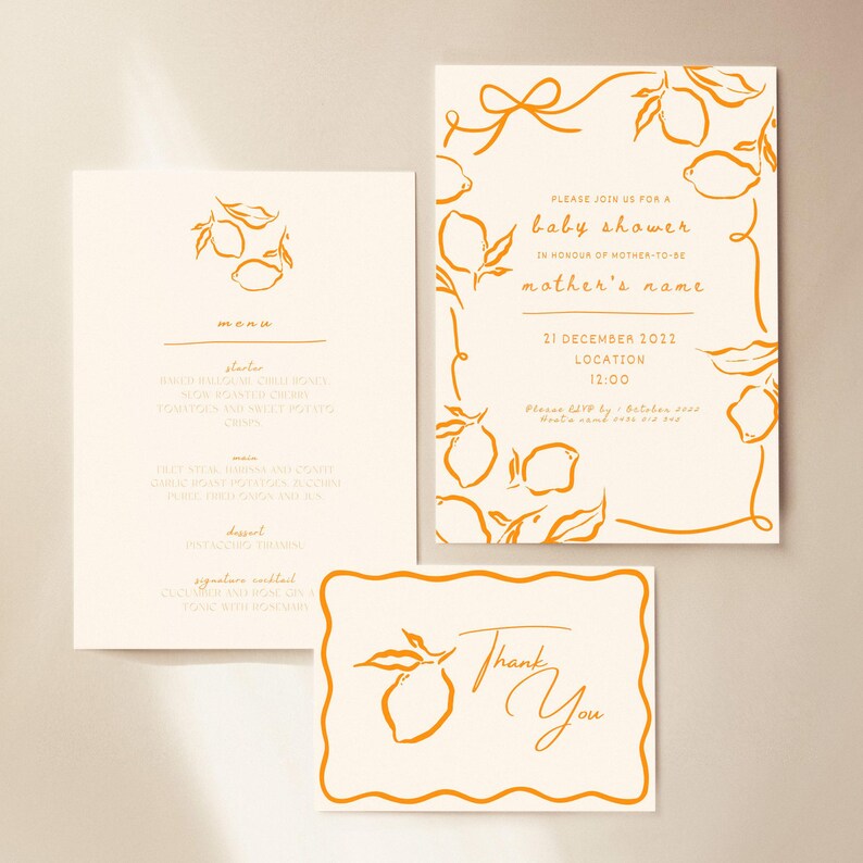 May include: A set of baby shower stationery with a lemon theme. The set includes a menu, invitation, and thank you card. The invitation reads "Please join us for a baby shower" with the date and time. The cards have orange lemon illustrations.