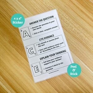 May include: A white 4 x 6 inch sticker with the text "ANSWER THE QUESTION", "CITE EVIDENCE", and "EXPLAIN YOUR THINKING". The sticker has a teal circle that says "Peel & Stick". The sticker is on a wooden surface.