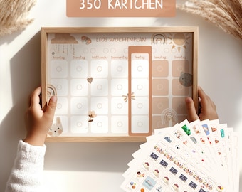 May include: A wooden framed weekly planner with a white background and colorful illustrations. The planner has a section for each day of the week, Monday through Sunday. The planner is labeled "Leo's Wochenplan" and includes 350 stickers with various illustrations.
