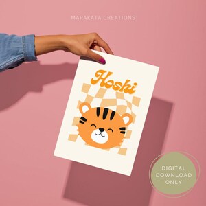 May include: A digital printable featuring a cute cartoon tiger with a checkered background and the name "Hoshi" in a retro font. The print is available for digital download only.