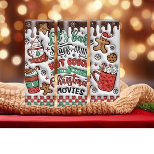 May include: Three white insulated tumblers with a Christmas theme. The tumblers feature a red and green plaid pattern, a gingerbread man, and the text "Let's bake stuff - drink hot cocoa and watch Christmas movies".