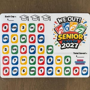 May include: A white rectangular savings tracker card featuring a grid of colorful numbered squares and dice labels. The top right displays the text WE OUT! SENIOR CLASS OF 2027 with playing card graphics. Includes spaces for Each Cap and Total Saved.