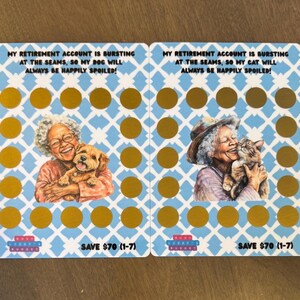 May include: Two scratch-off cards with a blue and white pattern and gold circles. One card shows a woman with a dog, the other with a cat. Text reads: "My retirement account is bursting..."