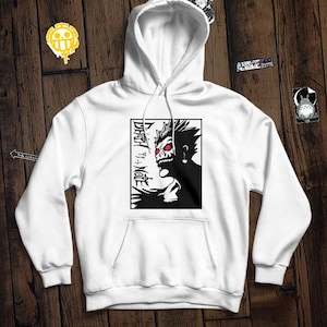 May include: White hooded sweatshirt featuring a black and white graphic print of a character with red eyes. The text "DEATH NOTE" is printed vertically on the left side of the graphic.