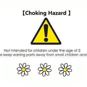 May include: A yellow triangle warning sign with an exclamation point inside. The text "Choking Hazard" is above the triangle. The text "Not intended for children under the age of 3" is below the triangle. The text "Please keep earring parts away from small children and pets" is below the warning text. Three white daisies with yellow centers are below the text.