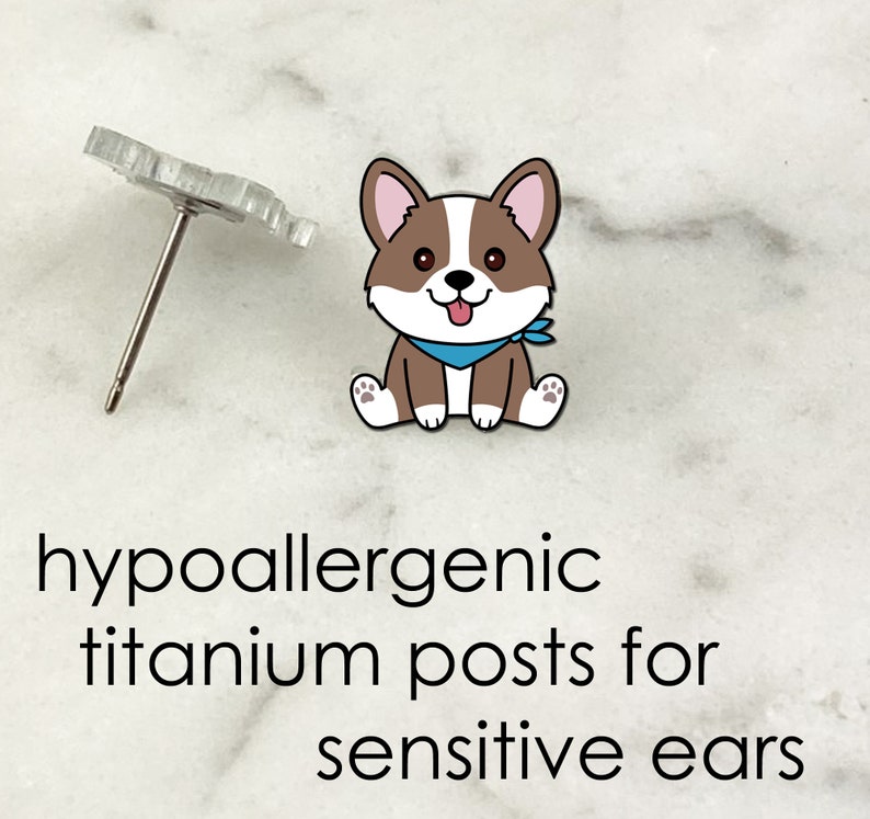 May include: Hypoallergenic titanium posts for sensitive ears.  A pair of cute cartoon corgi dog earrings with a blue bandana.