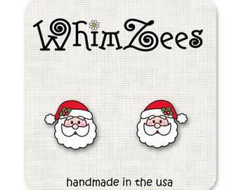 Puede incluir: Un par de pendientes de Papá Noel con gorros rojos, barbas blancas y ojos negros. Los pendientes están hechos a mano en los Estados Unidos y llevan el texto "Whimzees".