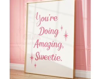 May include: A white framed poster with pink text that reads "You're Doing Amazing, Sweetie." The text is surrounded by pink stars.