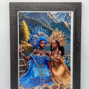 May include: Framed art print featuring two women in ornate gowns and headdresses. One woman wears a blue gown with matching headpiece, the other a gold gown. The background shows a lake, mountains, and a peacock.