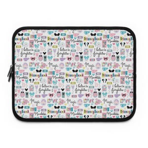 May include: A white laptop sleeve with a repeating pattern of colorful Disney-themed icons and text. The icons include Mickey Mouse ears, castles, and hearts. The text includes "Disneyland", "Monstketuer", "Magic", "Love", and "I believe in fairytales!"