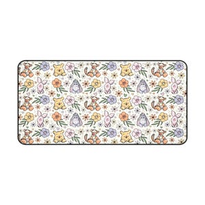 May include: A white ceramic mug with a black handle and the text "But First, Coffee" in a black, handwritten-style font. The mug is on a white surface.