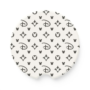 May include: White ceramic car coaster with a black and white pattern of Mickey Mouse ears, the Disney logo, and diamonds.