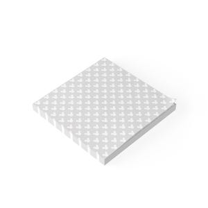 May include: A square stack of light gray sticky notes featuring a repeating white pattern of small, three-circle mouse head silhouettes arranged in a grid. The top sheet is slightly curled at the corner, revealing the thickness of the paper stack.
