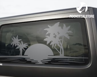 May include: A gray car with a rear window decal of a sunset with palm trees. The decal is white and the text "MOONDECALSTORE" is visible in the top right corner of the image.