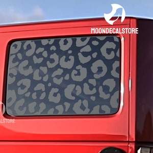 May include: A red vehicle with a rear window featuring a gray leopard print decal. The decal is on the back window of the vehicle. The decal is a sticker that can be applied to any smooth surface. The decal is made of high-quality vinyl and is waterproof and UV resistant. The decal is easy to apply and remove. The decal is perfect for adding a touch of style to your vehicle.