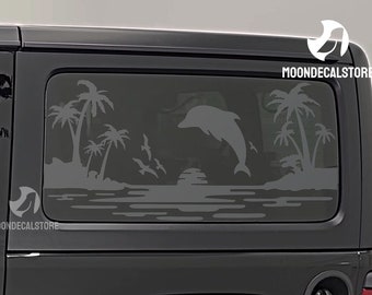 May include: A black car with a rear window decal featuring a silhouette of a dolphin jumping over a sunset with palm trees and seagulls. The decal says "MOONDECALSTORE" in white text.