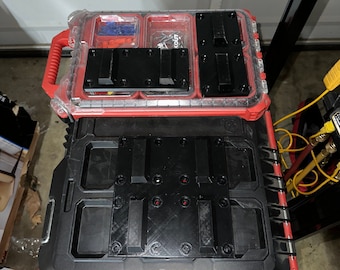 May include: A black and red tool box with a clear plastic top. The top has several compartments for storing small items. The bottom of the box has a black insert with multiple slots for holding tools.