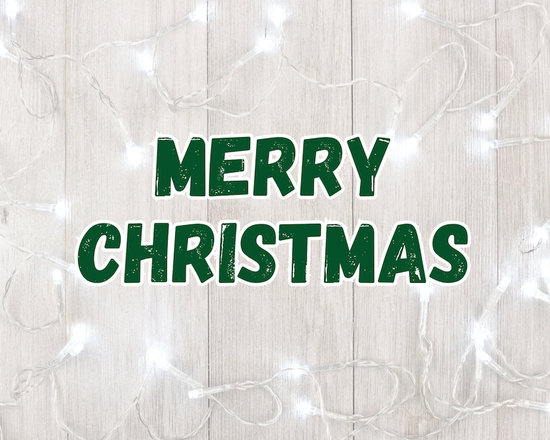 May include: White Christmas lights strung on a woodgrain background with the text "Merry Christmas" in green.