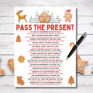 May include: A festive Christmas-themed print with the text "Pass the Present" and gingerbread house illustrations. A black pen rests on the white paper, alongside gingerbread cookie decorations. Perfect for holiday gifting or decor.