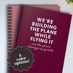 We're Building the Plane While Flying It Notebook - Funny Work Journal for Corporate Jargon, Eye Twitch Humor - Multiple Colors Available