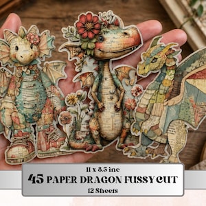 May include: A collection of three paper dragon cutouts with floral accents, in shades of teal, beige, and red. The dragons are held in a hand, and the text on the bottom reads "45 PAPER DRAGON FUSSY CUT" and "12 Sheets". The paper measures 11 x 8.5 inches.