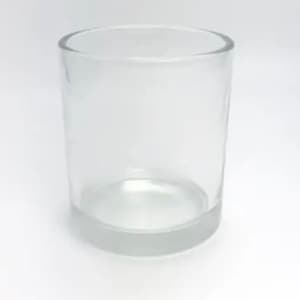 May include: A clear glass candle jar with a rounded bottom and straight sides.