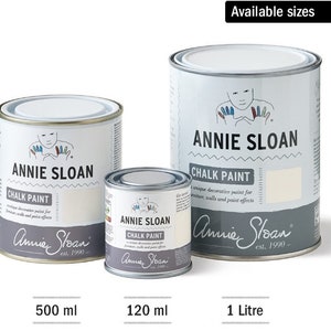 May include: Three sizes of Annie Sloan Chalk Paint in white cans. The cans are labelled with the brand name and the text "Chalk Paint". The smallest can is 120 ml, the middle can is 500 ml, and the largest can is 1 litre.
