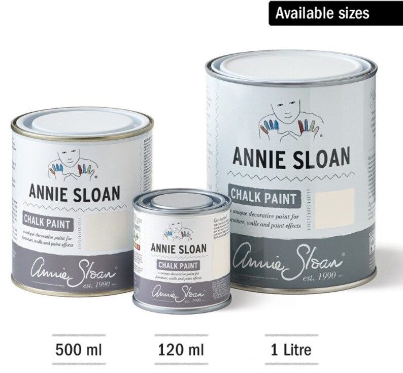 May include: Three sizes of Annie Sloan Chalk Paint in white cans. The cans are labelled with the brand name and the text "Chalk Paint". The smallest can is 120 ml, the middle can is 500 ml, and the largest can is 1 litre.