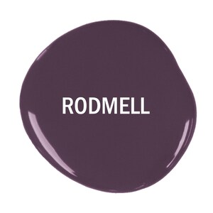 May include: A close-up of a dark purple paint swatch with the word "RODMEL" printed in white.